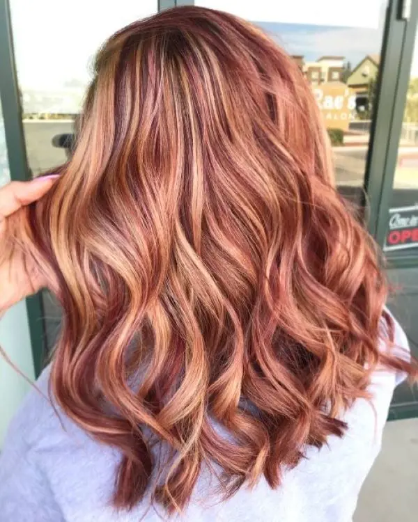 Red and blonde highlights are a cool twist to the classic blonde hair that incorporates sweet shades of red and pink