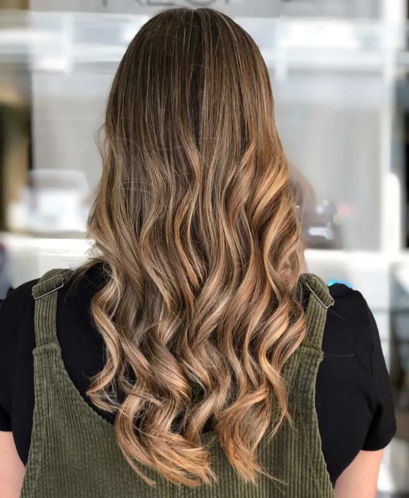 Caramel blonde balayage highlights is a great choice for brunettes craving dimension without commitment