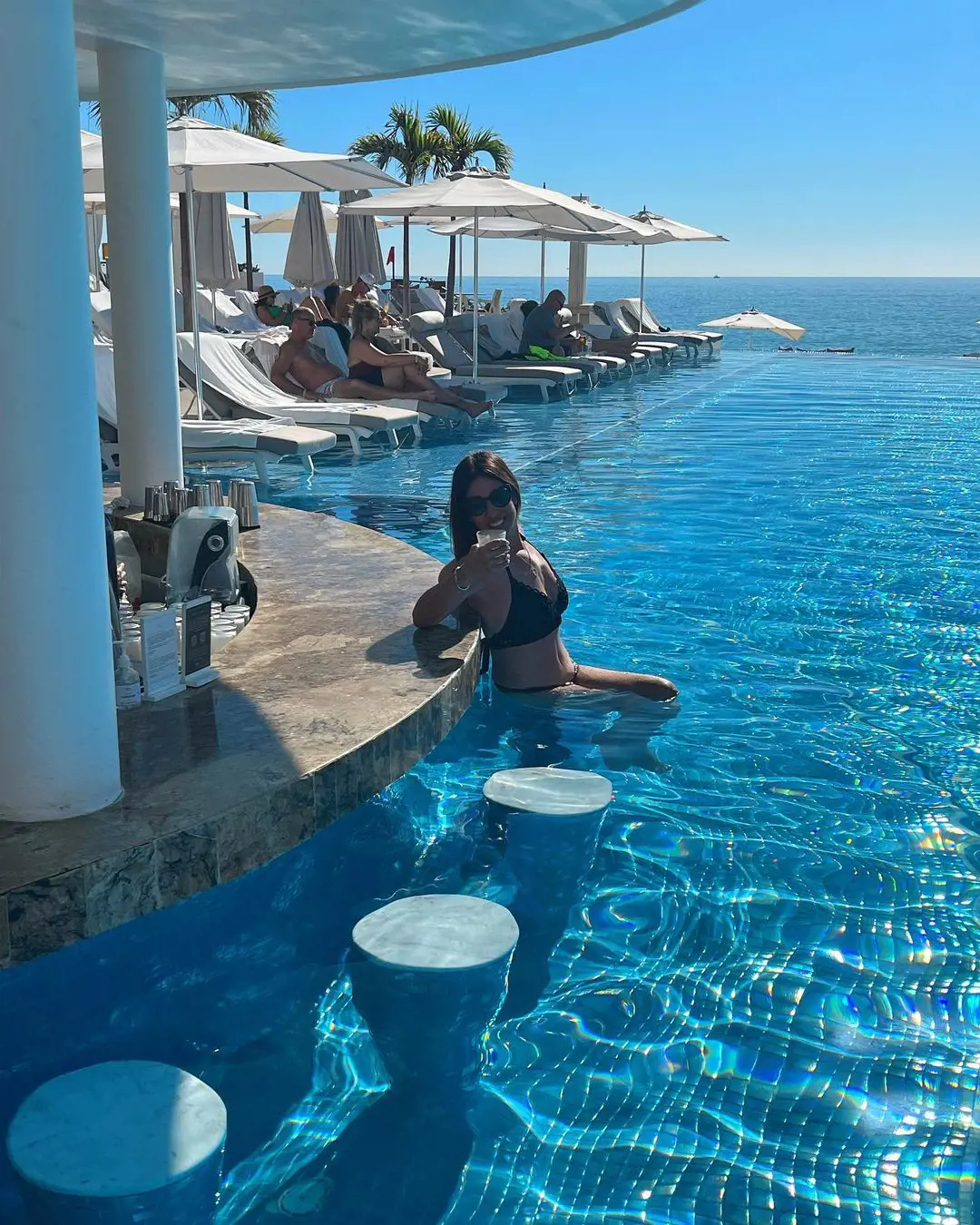 She enjoying her vacation in the pool at Cabo San Lucas, Mexico