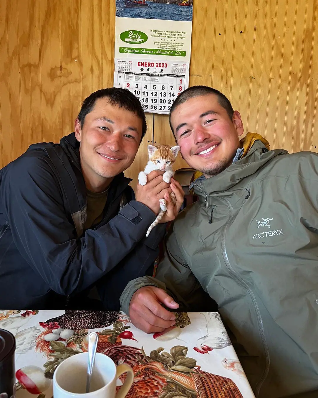 Oliver and Wilson with a kitten during their expedition at Carretera Austral, Patagonia.