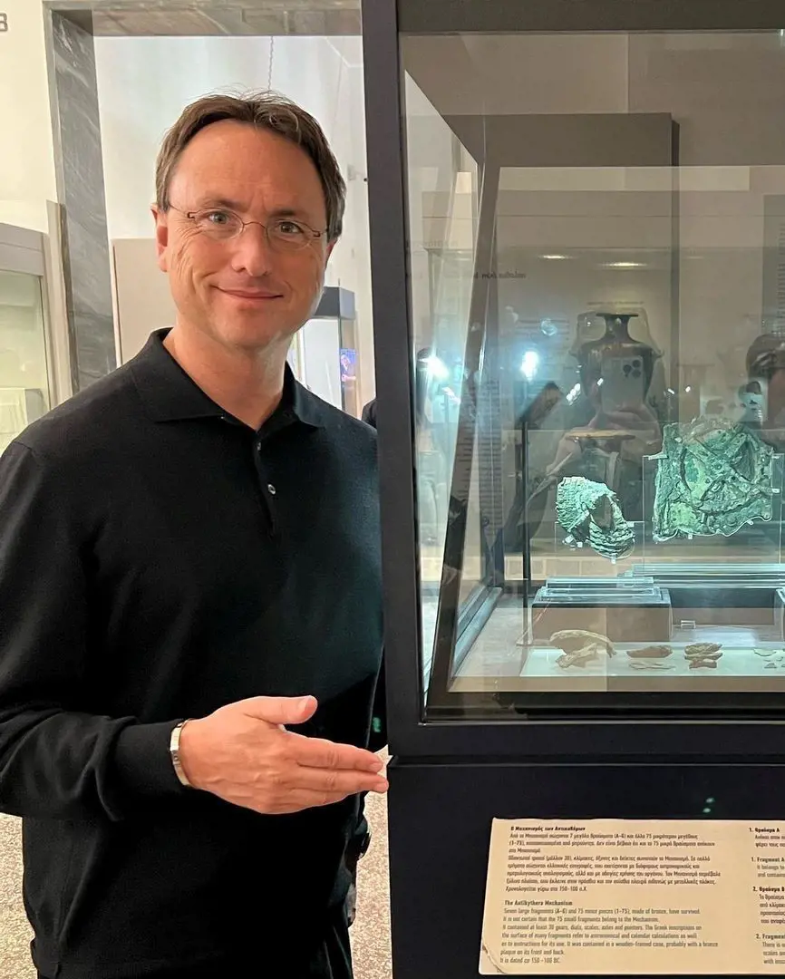 The real estate tycoon at National Archaeological Museum showing The Antikythera Mechanism -a device described as the oldest computer, dating to 205 BC