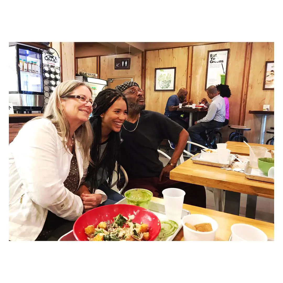 Jasmine posing with her mother and father while enjoying food in  Philadelphia in 2017