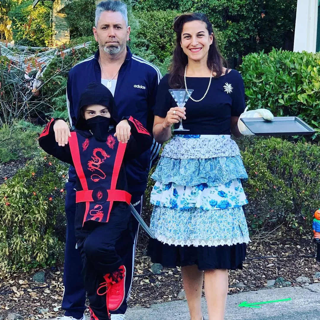 Shepos, Chris, and their son Nico celebrate Halloween where the chef wear a 1950's housewife dress and their child a ninja