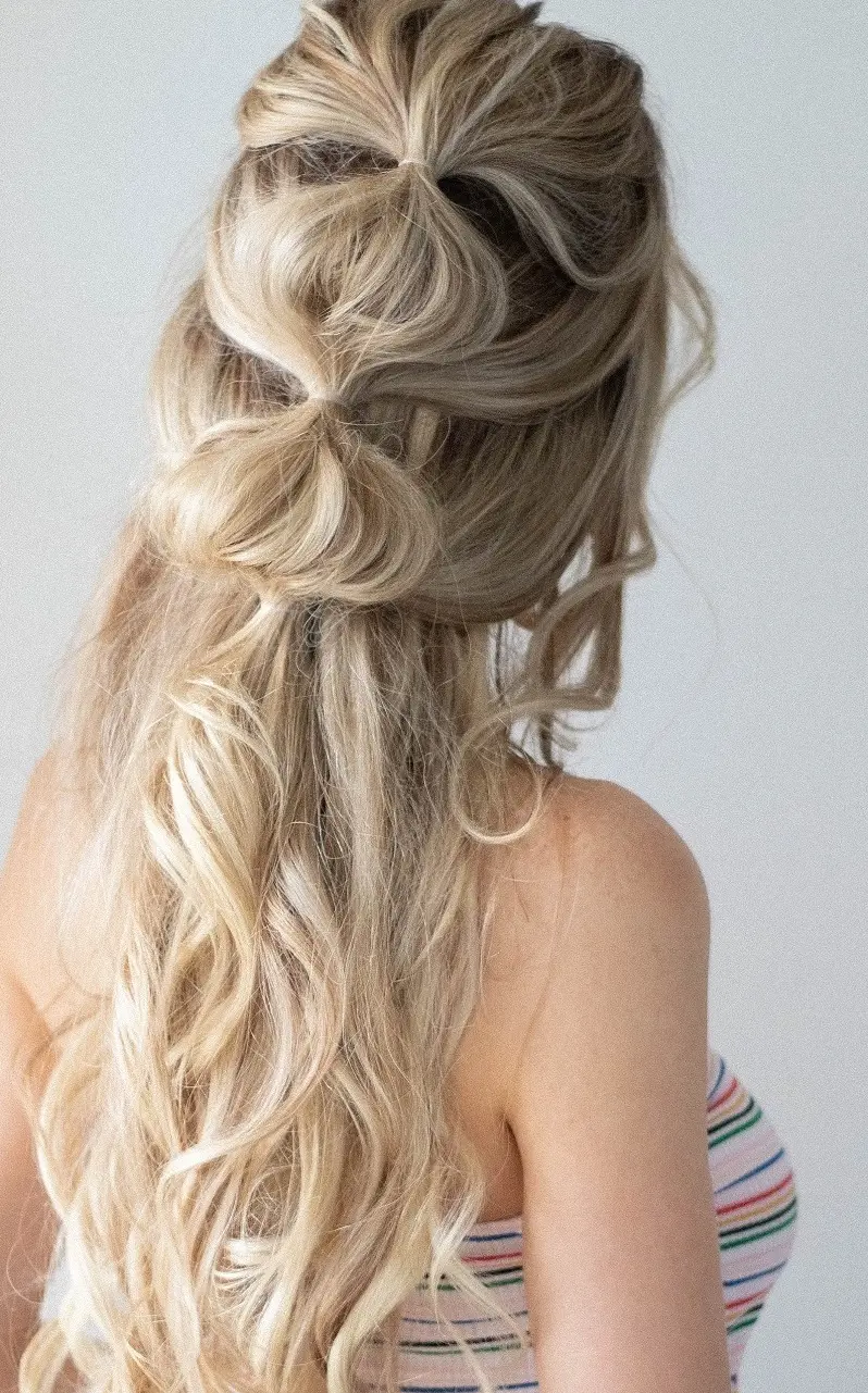 The bubble half-up style, half up featuring a bubble braid is a fun style for any event
