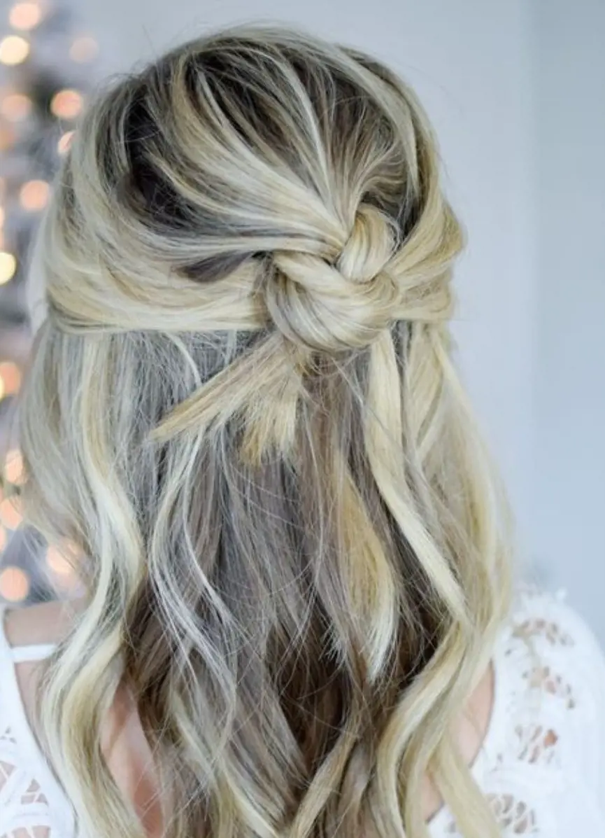 This  Knotted Half-Up  is a trendy and stylish hairdo that adds a touch of flair to your everyday appearance