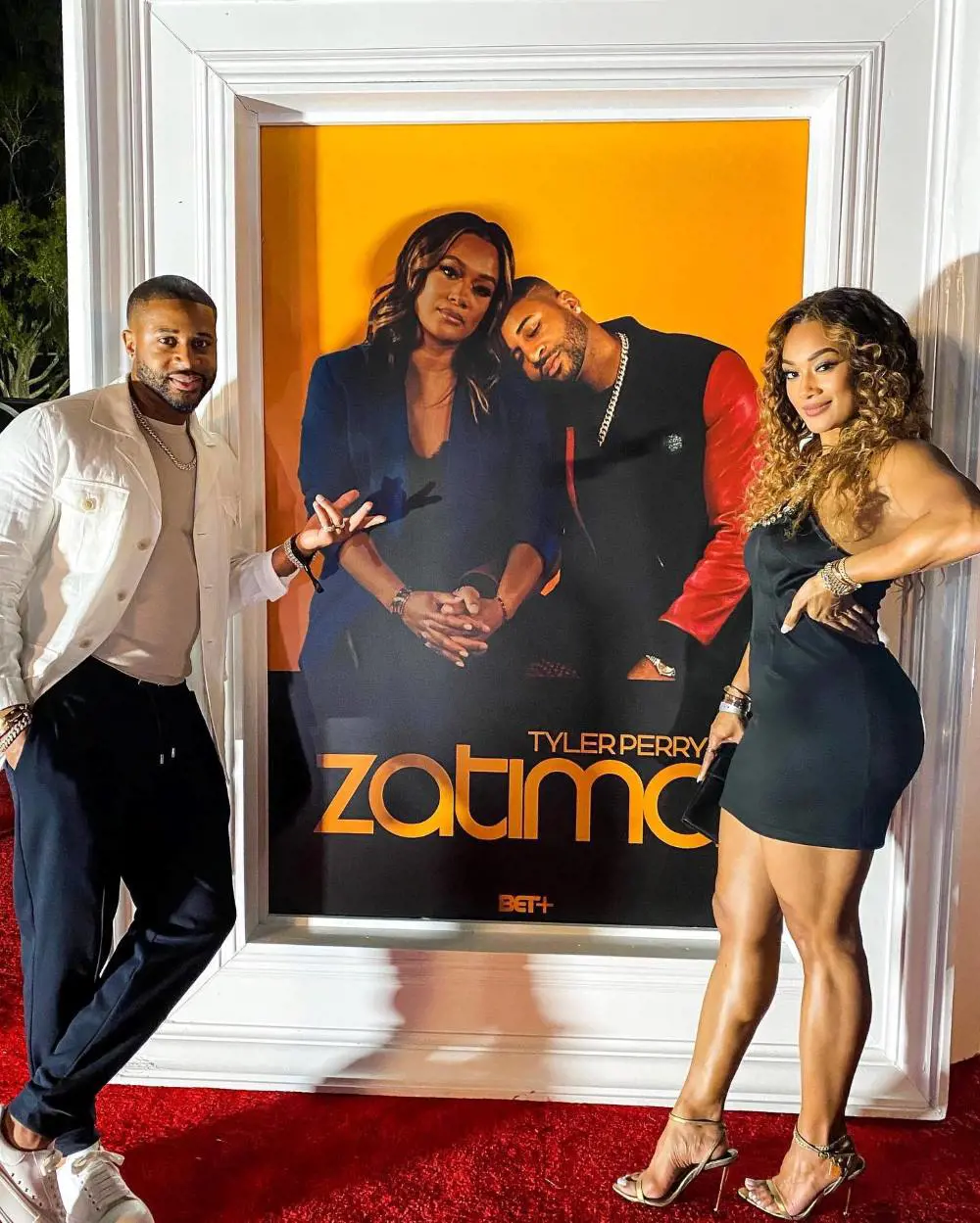 Zatima stars Ellis and Renee Hayslett pictured together in front of the series' poster